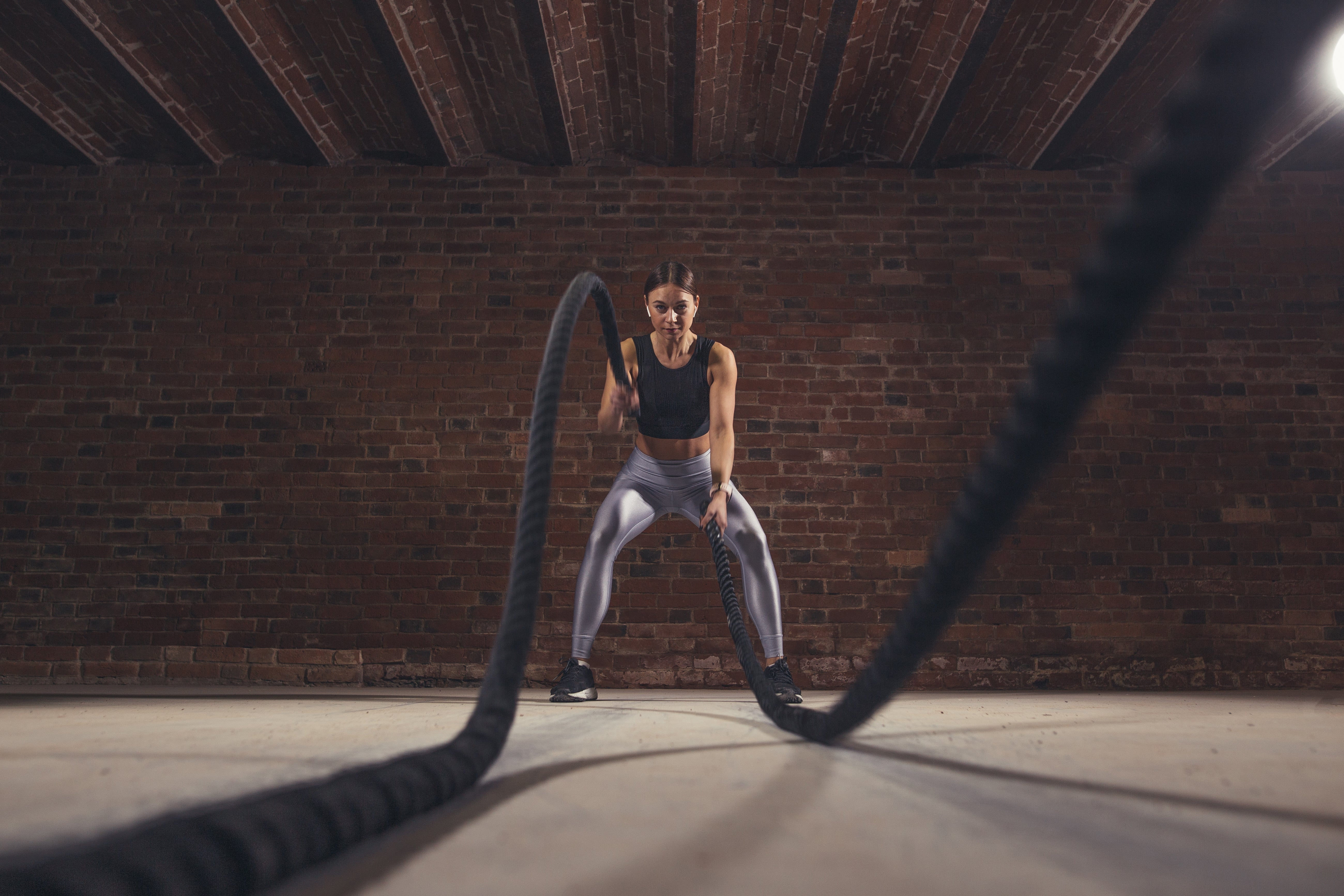 women using battle ropes