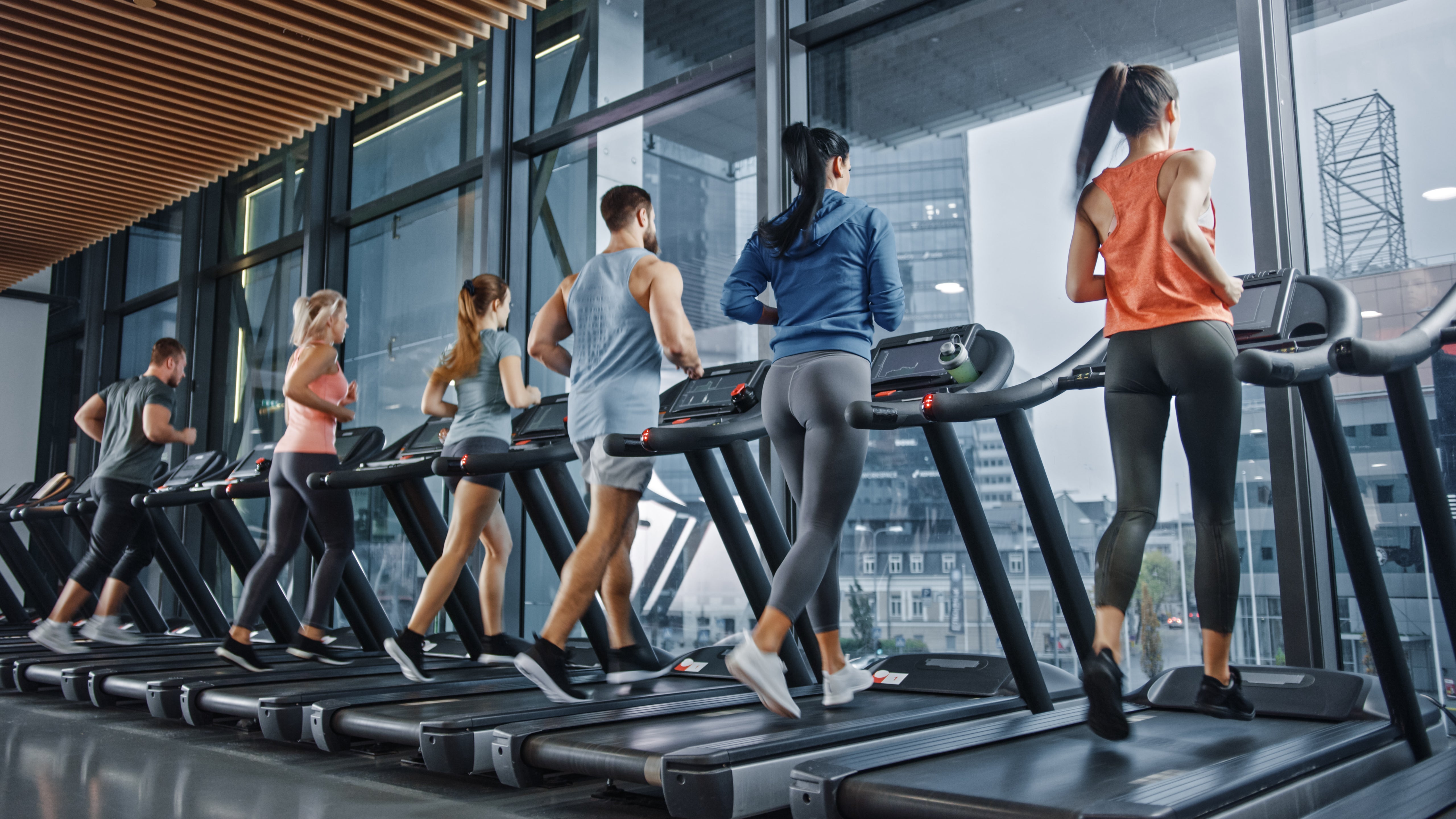 Multiple people using multiple treadmills