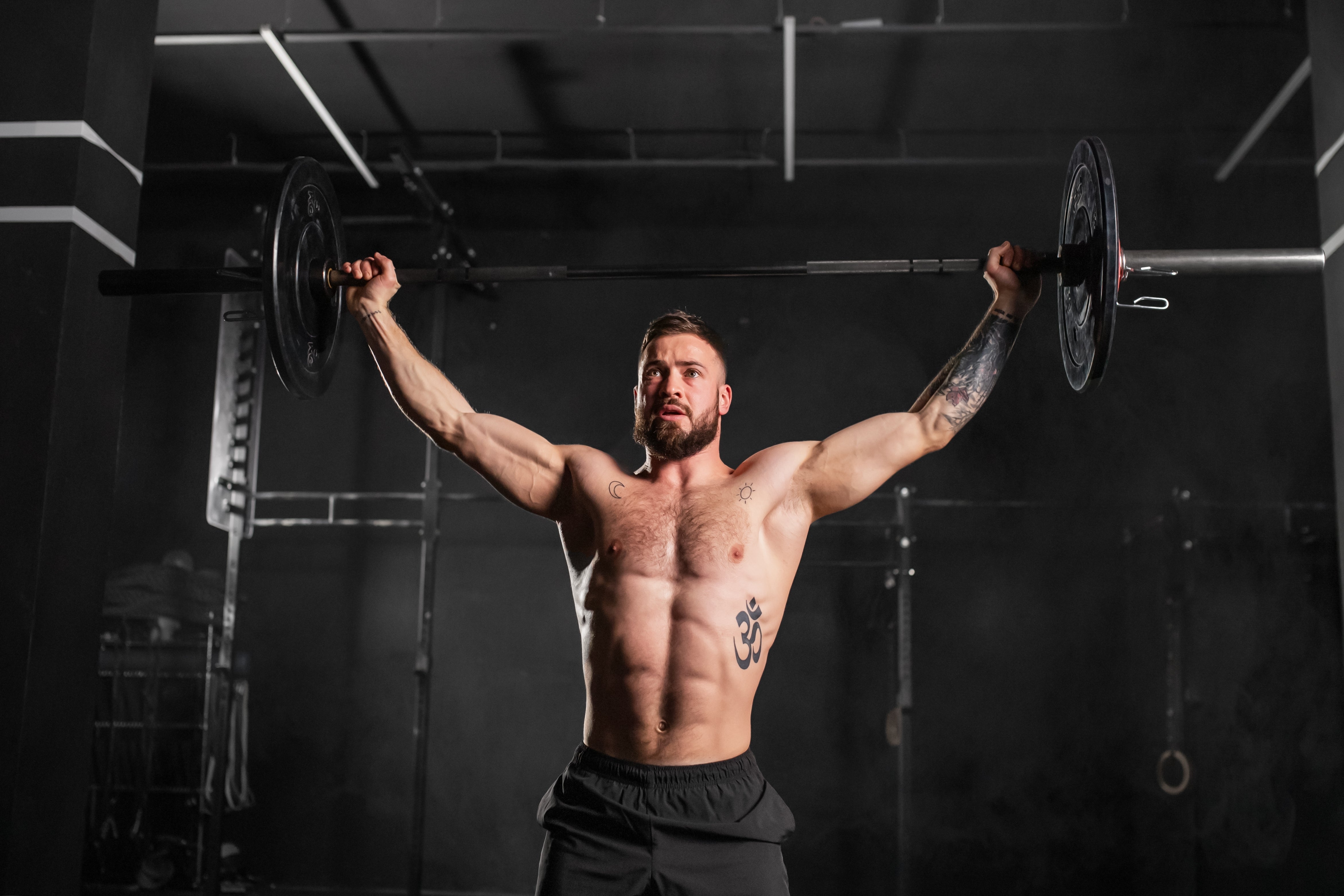 Muscular man lifting barbell