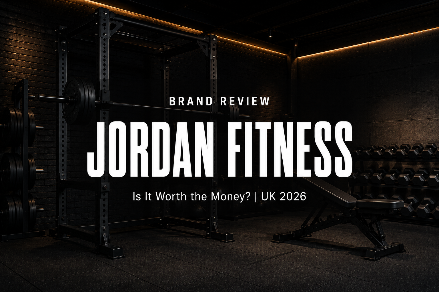 Jordan Fitness brand review header — premium black power rack, loaded Olympic barbell, bumper plates and dumbbells in a high-end UK gym