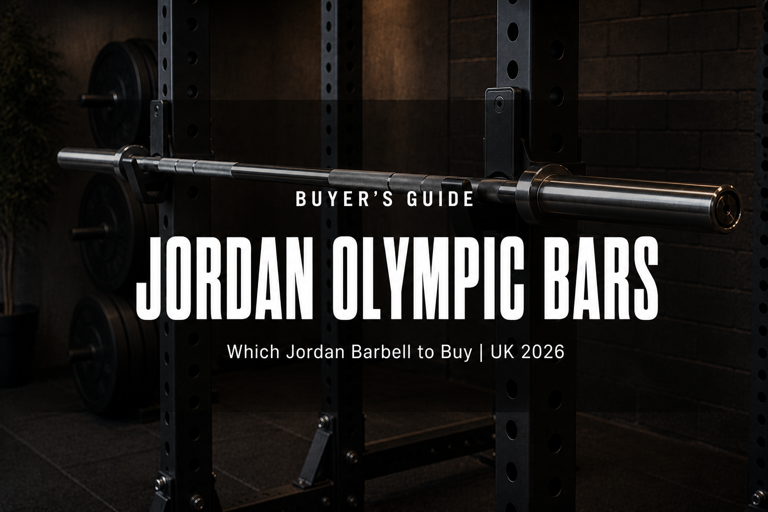 Premium brushed steel Jordan Olympic barbell with knurled grip on the J-hooks of a black power rack in a high-end UK home gym