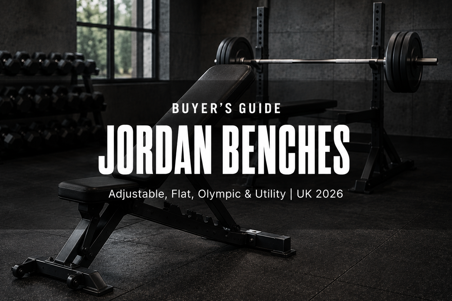 A black commercial adjustable weight bench set to incline in front of an Olympic bench with a loaded barbell in a modern UK gym