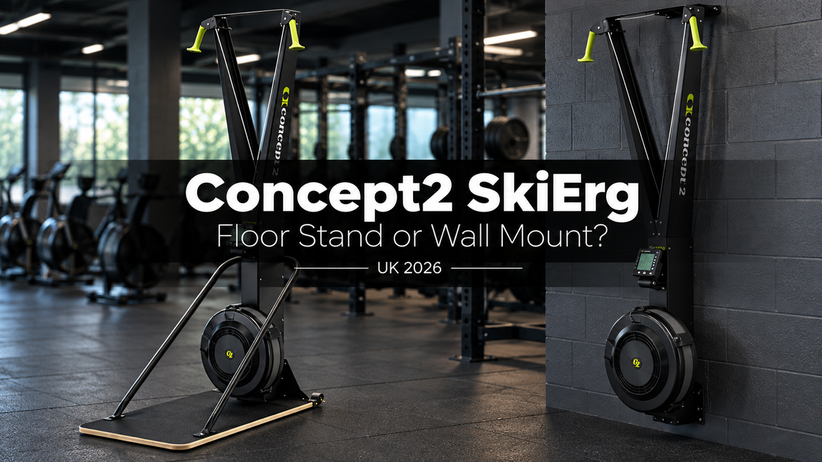 Two Concept2 SkiErg machines with PM5 monitors, one on a floor stand and one mounted to a gym wall, in a commercial gym