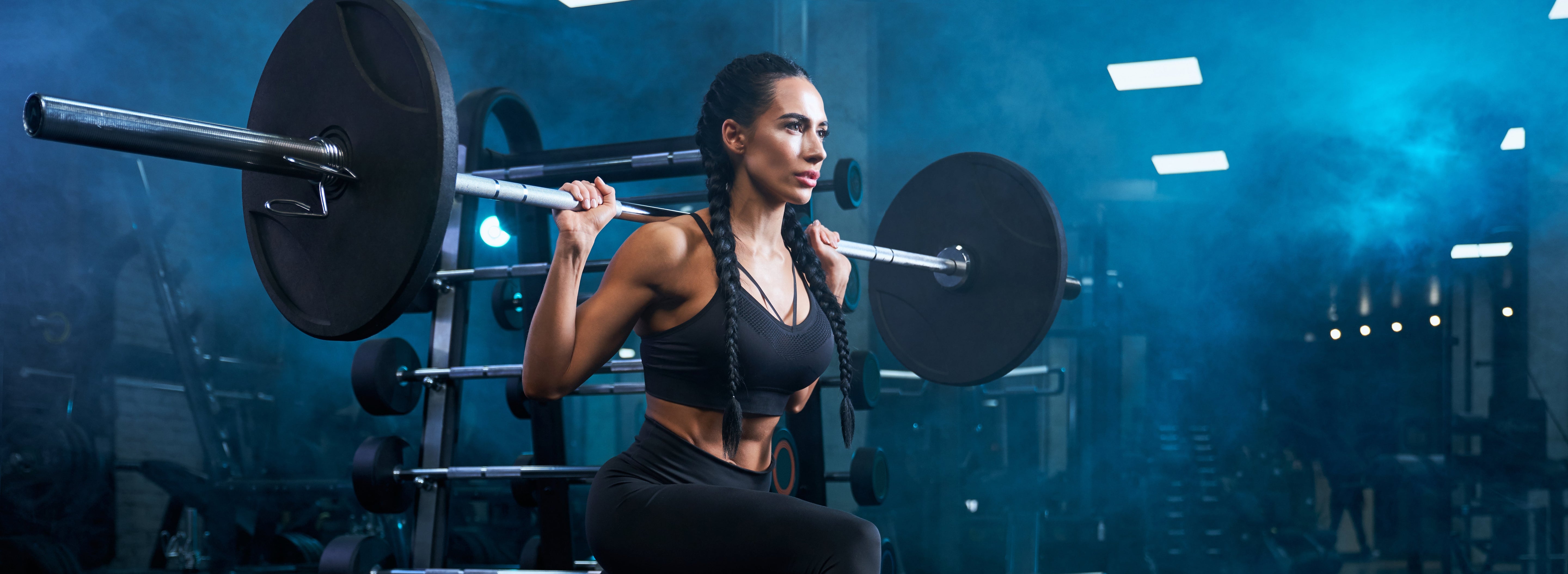 Woman squatting with barbell
