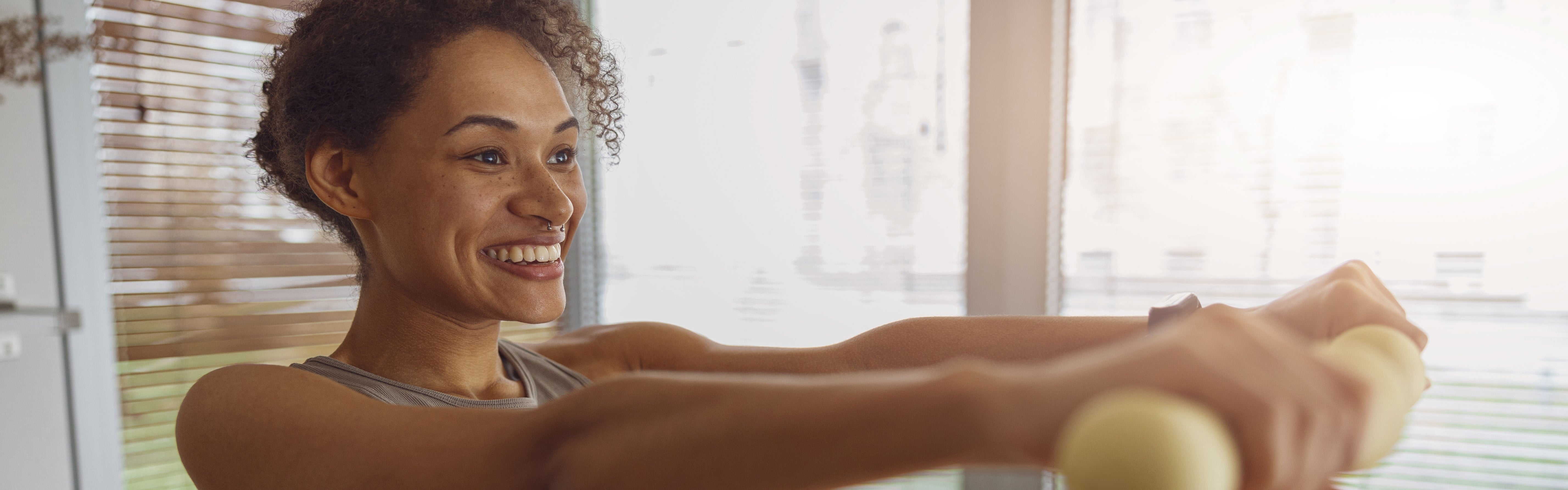 women raising small dumbbells