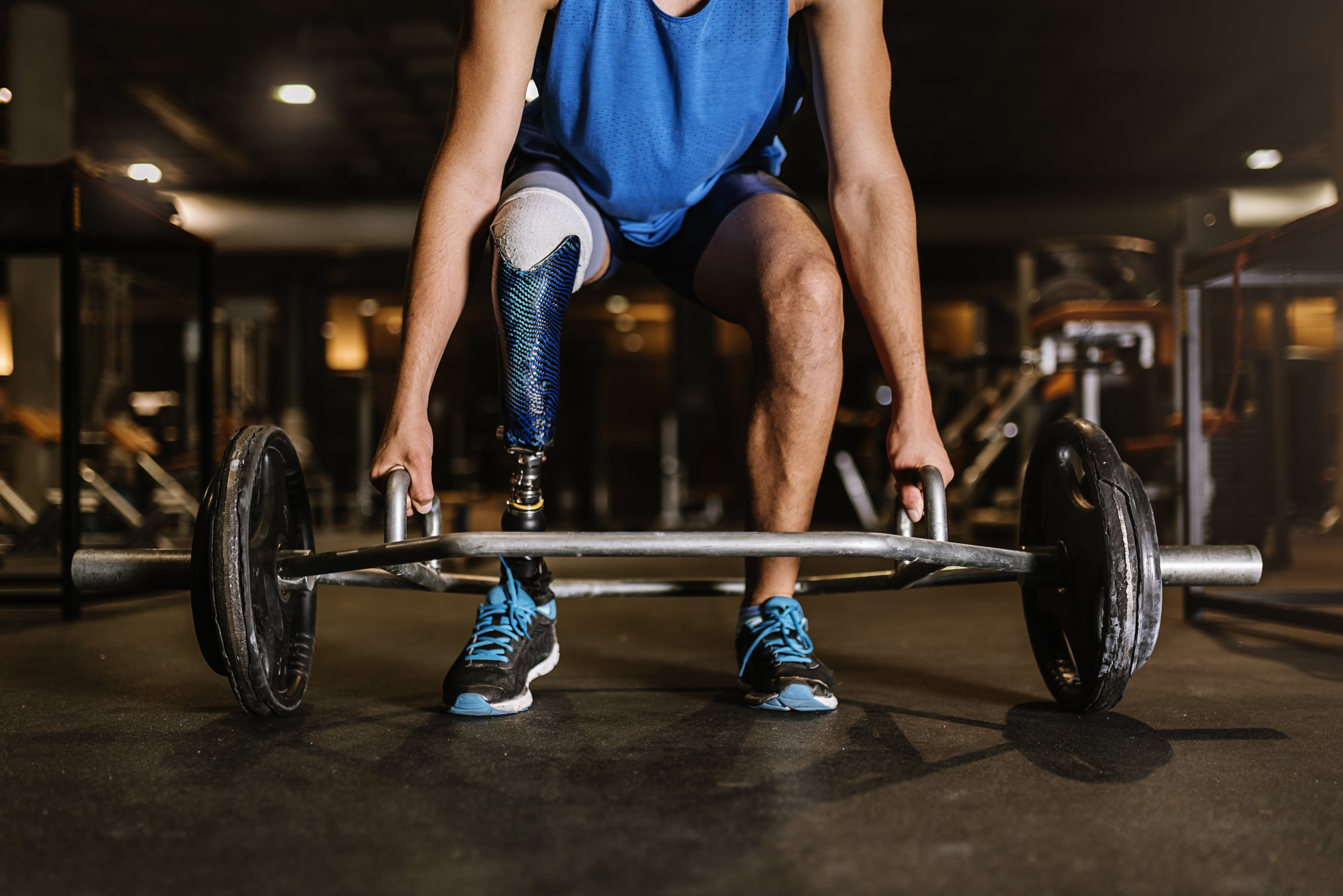 Woman with false leg lifting speciality bar